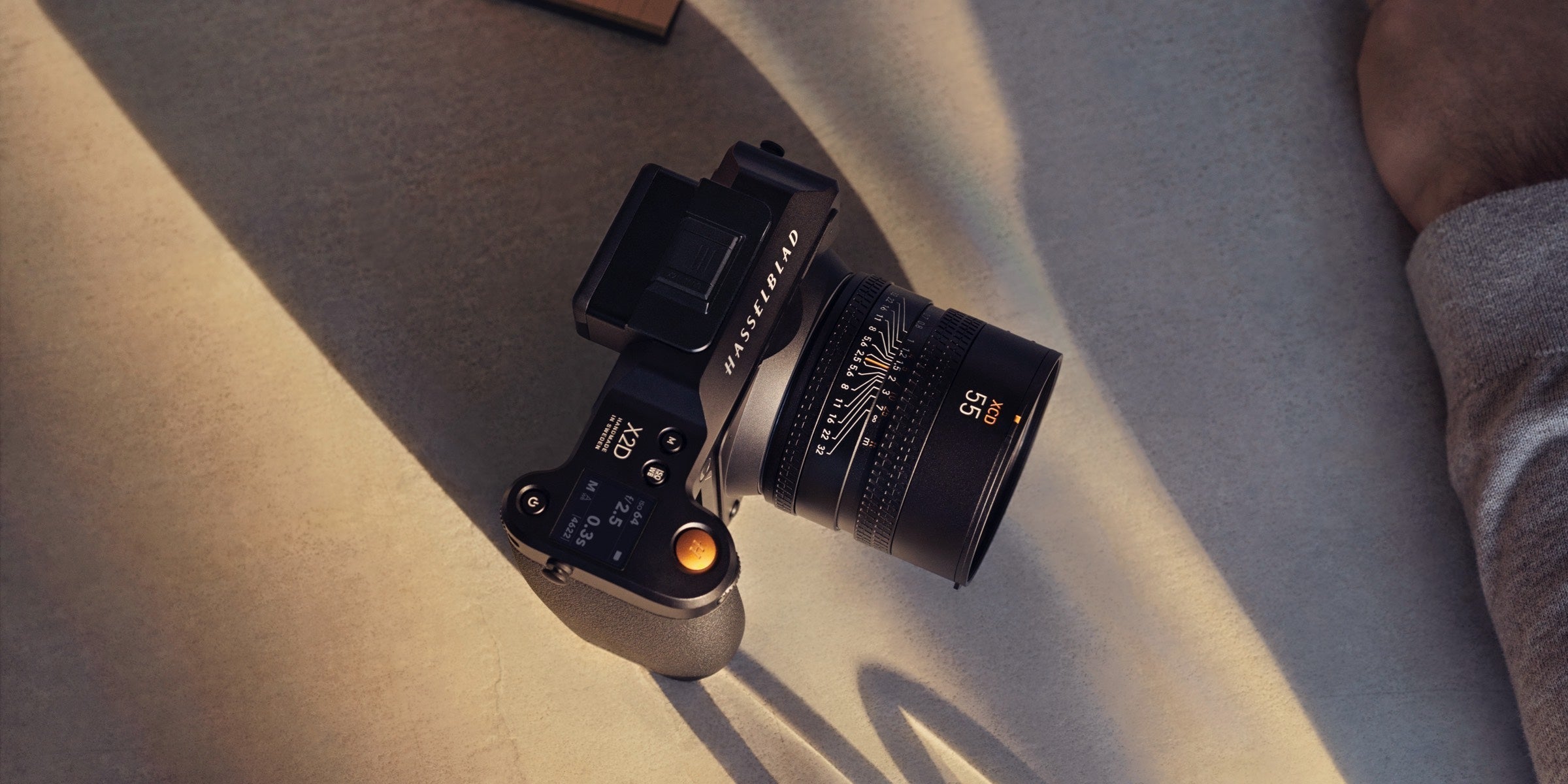 Hasselblad X2D camera with a 55mm lens resting in warm sunlight
