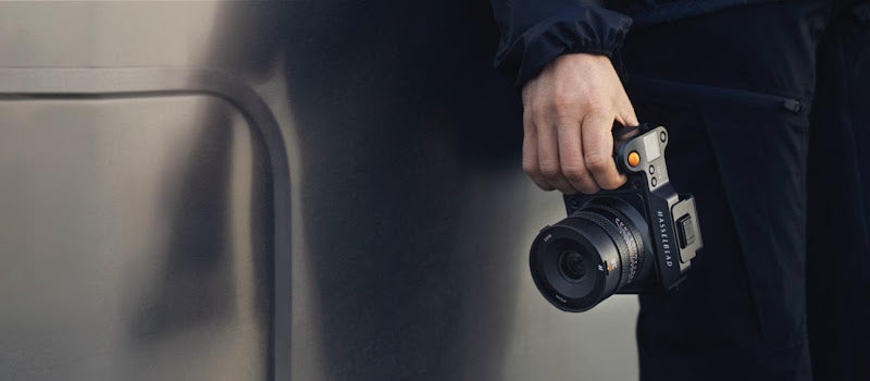 A medium format camera held by a photographer during a shoot